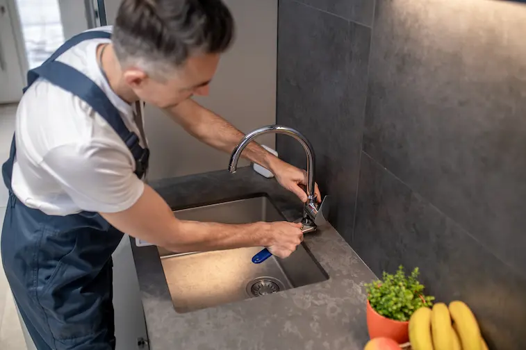 plumber fixing a sink